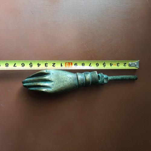 Antique bronze door knocker in hand shape