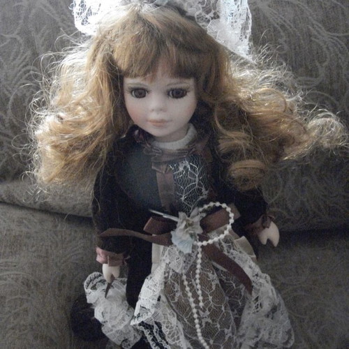 Porcelain doll used with base, box and accessories