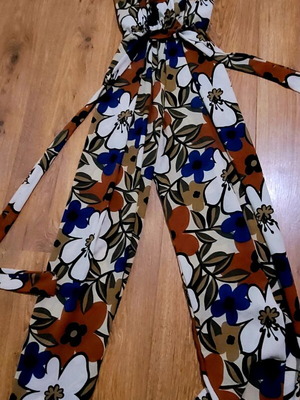 Elegant women's jumpsuit with floral motifs, like new