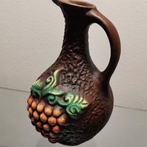 Clay jug used with embossed designs and grape cluster