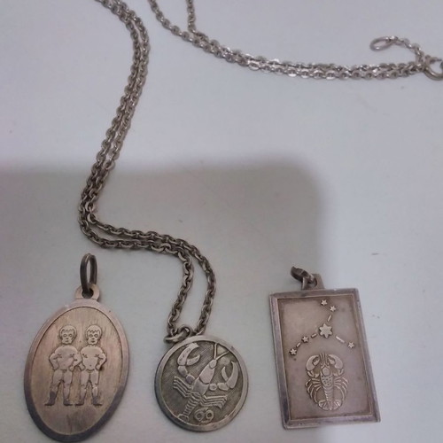Silver pendant necklace used with zodiac and catholic figures