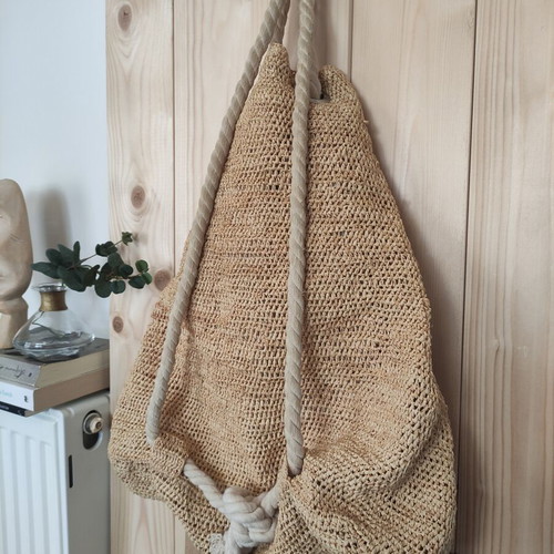 Boho straw backpack used with shells and rope straps, resort style