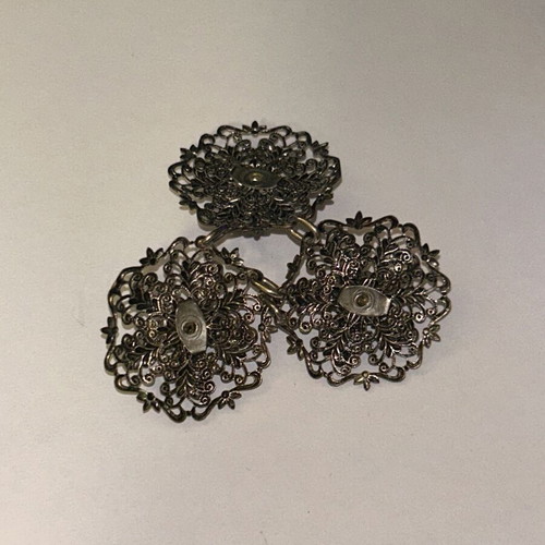 Vintage metal dress buckle with triple filigree design and green stones, like new