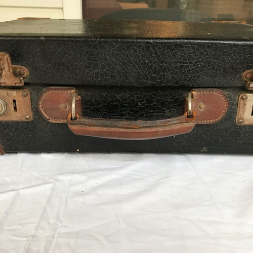 Small antique suitcase used with wear