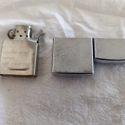 Windproof lighter with embossed metal emblem used