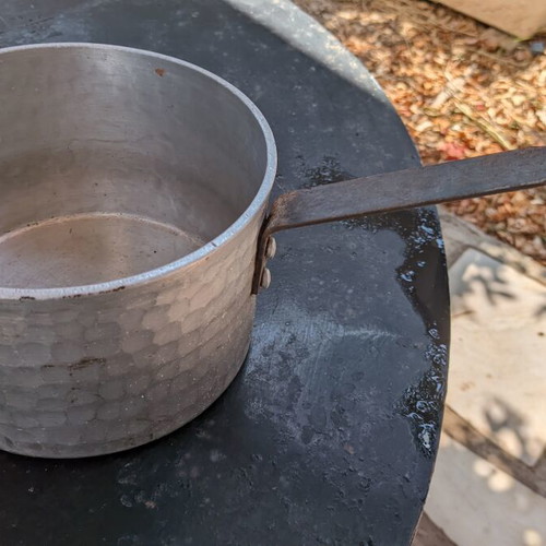 Traditional hammered aluminum saucepan 20 cm with long handle used