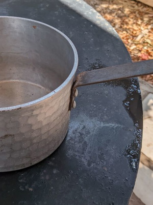 Traditional hammered aluminum saucepan 20 cm with long handle used