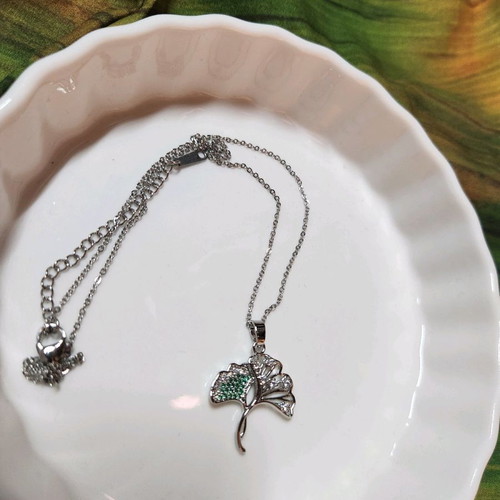 Silver necklace like new with tree design and green stones