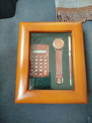 Gift set used in wooden case with calculator, watch and pen