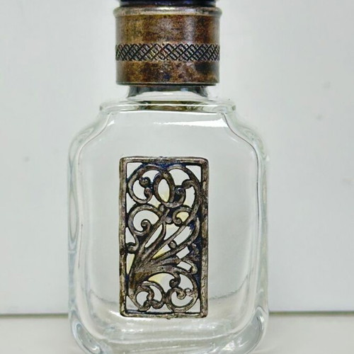 Vintage glass perfume bottle with metal decoration