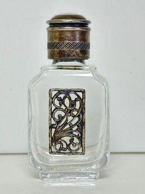 Vintage glass perfume bottle with metal decoration