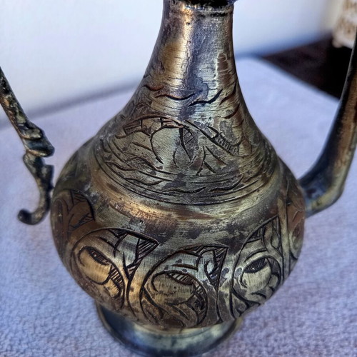Brass jug with engraved decoration, Asian origin