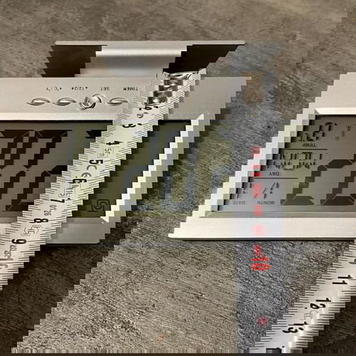 Digital table clock used with alarm and thermometer