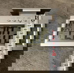 Digital table clock used with alarm and thermometer