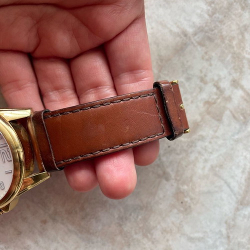 Tommy Hilfiger watch used with brown leather strap and gold dial