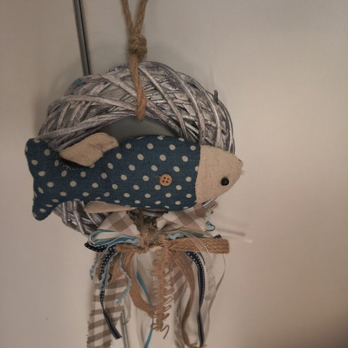 Handmade fabric fish decoration on white rattan wreath