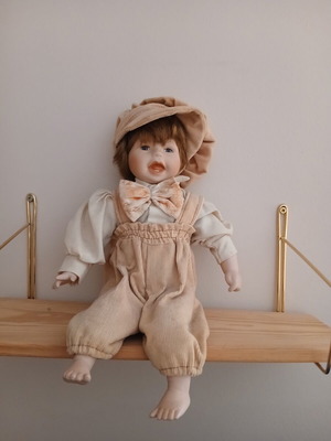 Porcelain doll sitting position for shelf or collection