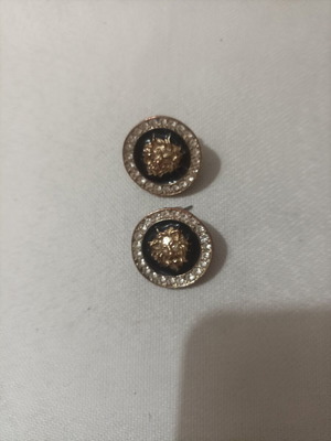Round earrings with lion head image on blue base