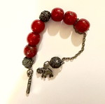 Worry beads with red beads and metal charms used, elephant