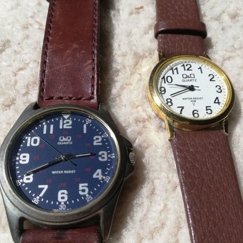 Q&Q wristwatches used with brown leather straps, blue one has glass damage