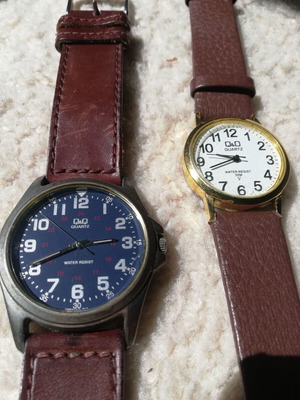 Q&Q wristwatches used with brown leather straps, blue one has glass damage