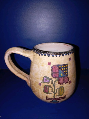 Ceramic mug used with painted floral decoration