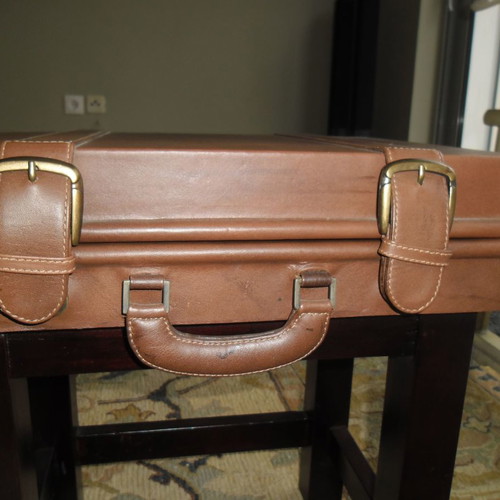 Leather folding table used with suitcase-shaped storage space