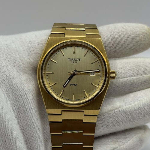 Tissot PRX Quartz watch with golden dial