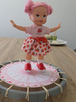 Doll with trampoline like new, laughs and jumps