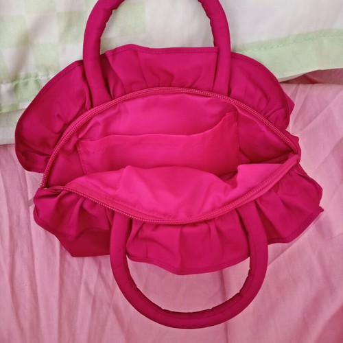 Pink handbag with zipper and handles
