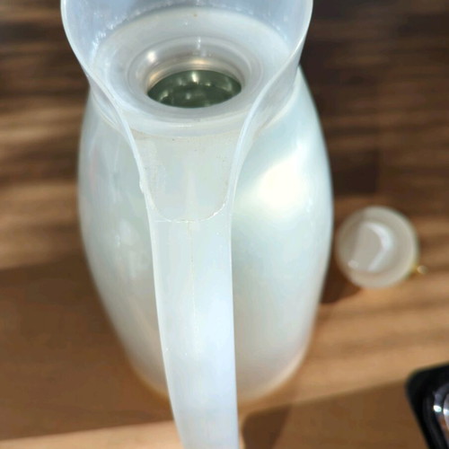 Household thermos like new, milky plastic with orange, glass interior