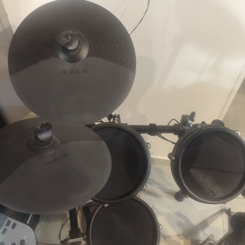 Alesis Nitro Mesh Kit electronic drums with Sony headphones and drumsticks holder