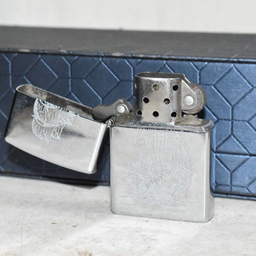 Zippo chrome lighter with sailboat design used