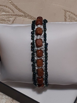 Handmade bracelet with brown wooden and green glass beads