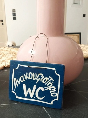 Wooden handmade frame with blue string and sign Ανακουφιστήριο W.C