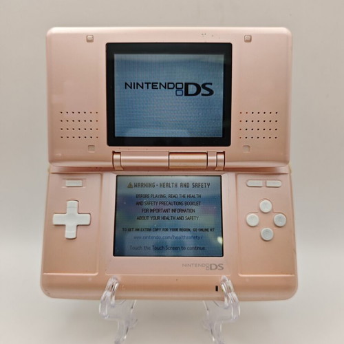 Nintendo DS pink handheld console used with charger and stylus