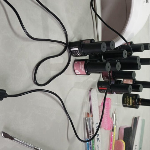 Manicure items used, set with buffers, files, drill, lamp