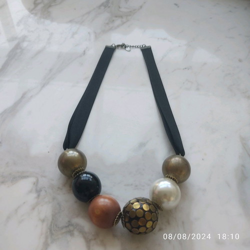 Accessorize necklace used with black thick ribbon and large beads