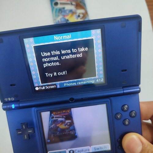 Nintendo DSi handheld console with Pokemon HeartGold game
