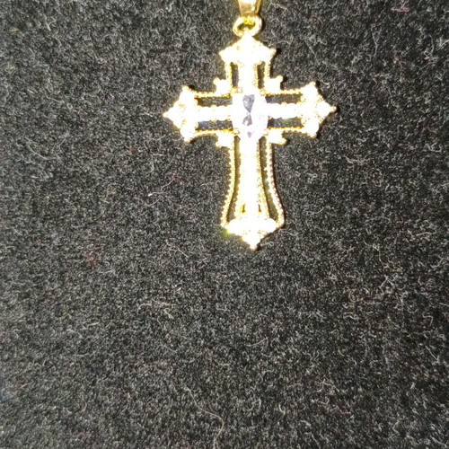 Women's cross new in gold color with white zircon stones