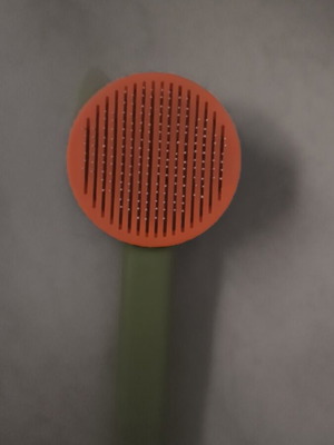 Cat grooming comb with hair removal button