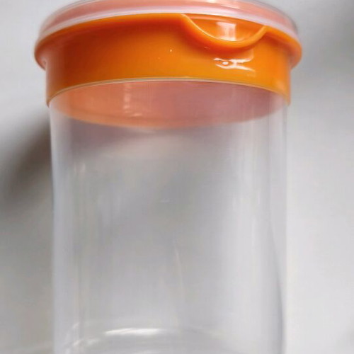 Storage container round like new, transparent with orange lid