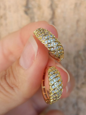 Gold-colored hoop earrings with white zircon stones, copper
