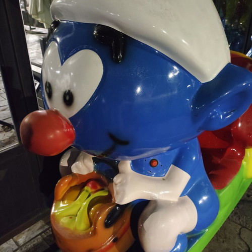 Smurf coin-operated rocking ride