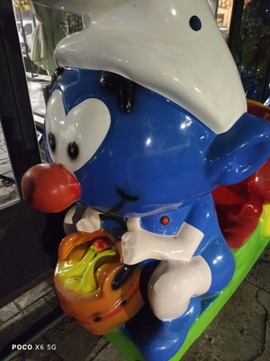 Smurf coin-operated rocking ride
