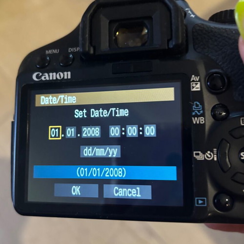 Canon EOS 450D camera used with charger and straps