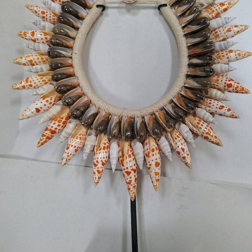 Decorative shell necklace like new on custom stand