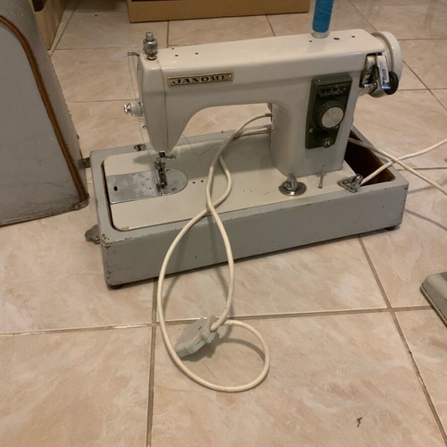 Electric collectible sewing machine used with carrying case