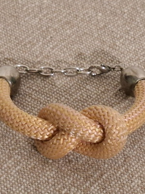 Knot bracelet like new, fabric light pale orange