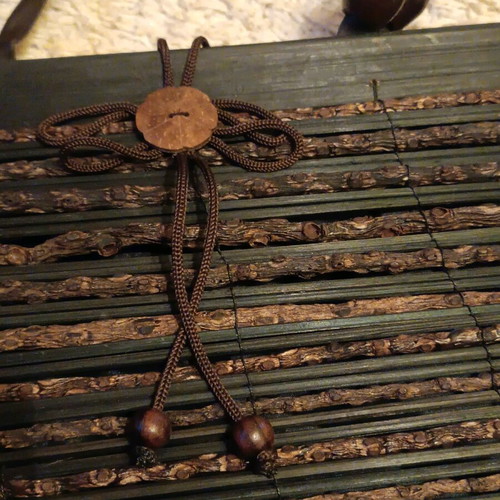 Wooden bag with slightly faded strap